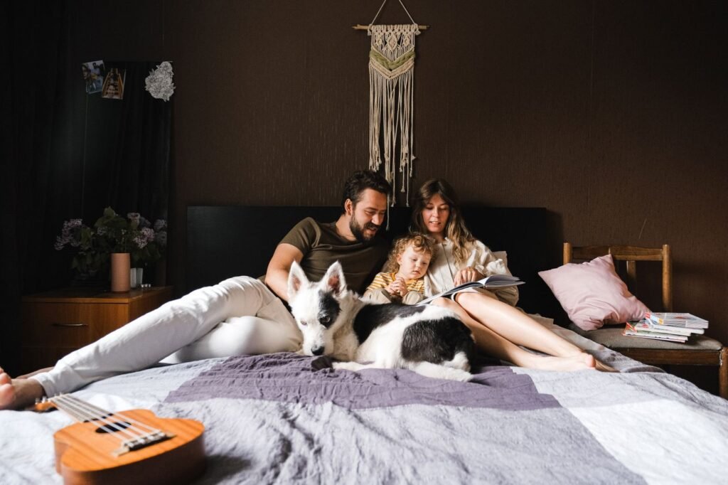 People reading together beside their dog